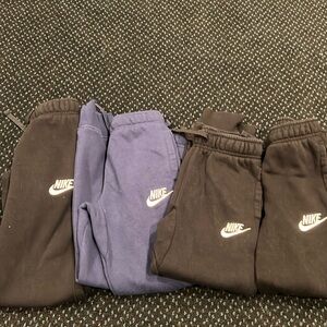 3 black Nike sweatpants and 1 navy so3 6/7
